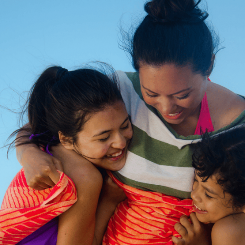 mother hugging daughter and son